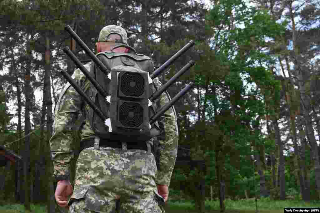 A Ukrainian soldier wears an “anti-drone backpack” during a demonstration of jamming devices in the Lviv region in May.
