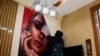 AFGHANISTAN -- An Afghan beautician removes a poster in a beauty salon in Kabul, Afghanistan, July 24, 2023.