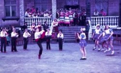 Children dancing in Opytne. Today less than 50 people remain and almost all of the buildings have been damaged or destroyed by the fighting.