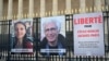This photograph shows portraits of French national Cecile Kohler (left) and her partner French Jacques Paris, along with a placard calling for their release, Paris, March 25