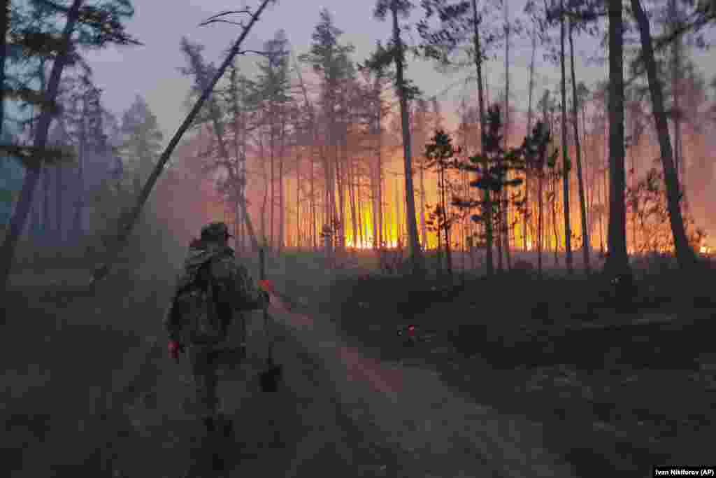 A volunteer heads off to fight a forest fire in Russia's Yakutia region on July 17. 