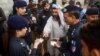Pakistani police check the documents of Afghan refugees during a search operation to find illegal immigrants on the outskirts of Karachi. (file photo)